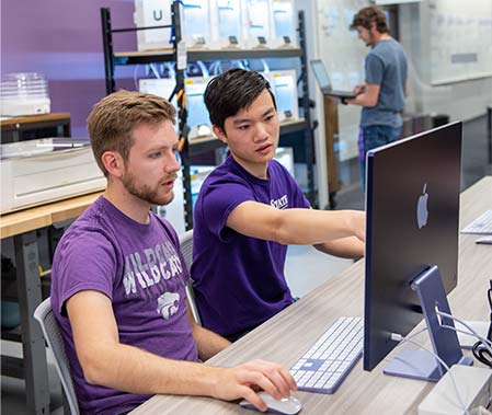 Two students using the Fabspace and 3D printers in the innovation lab.