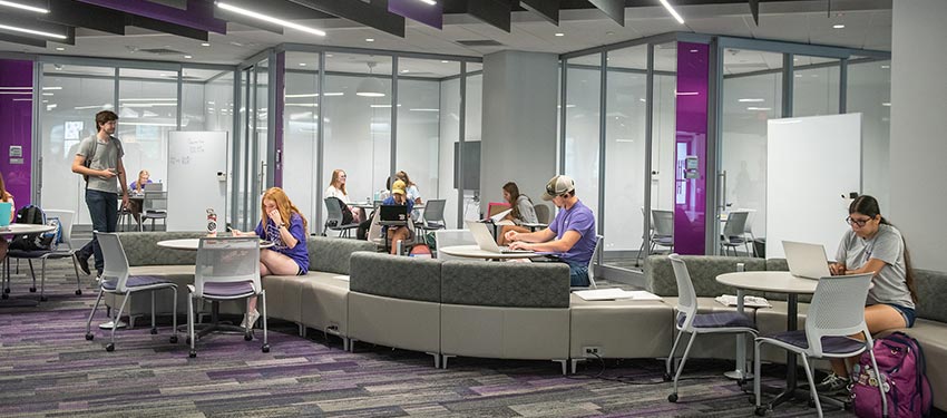 Students exploring first floor of Hale Library.