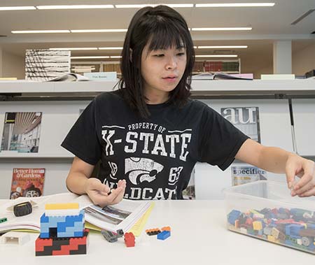 Weigel library student building with legos.