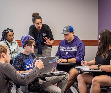 Staff assisting group of students.