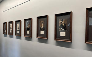 Hallway of framed photos showing former first ladies.